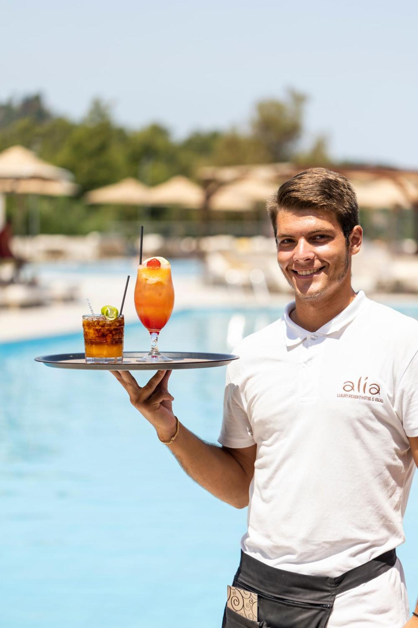 Alia Palace Hotel - Adults Only 16+ Chalkidiki Eksteriør billede A waiter serving drinks
